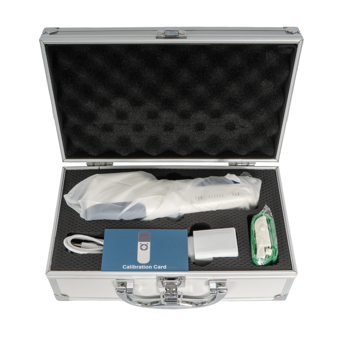 Open metal case with foam padding containing a calibration kit: blue Calibration Card, white handheld device in a bag, USB cable, a white adapter, and a green-wrapped accessory.