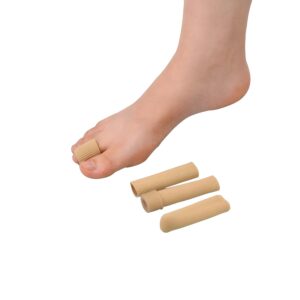 Close-up of a bare foot wearing beige silicone toe caps on several toes, with extra toe sleeves nearby.