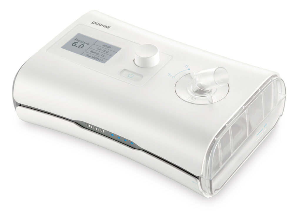 White CPAP machine with a control knob, display panel, and a clear humidifier/canister on the right; brand 'yuwell' visible.