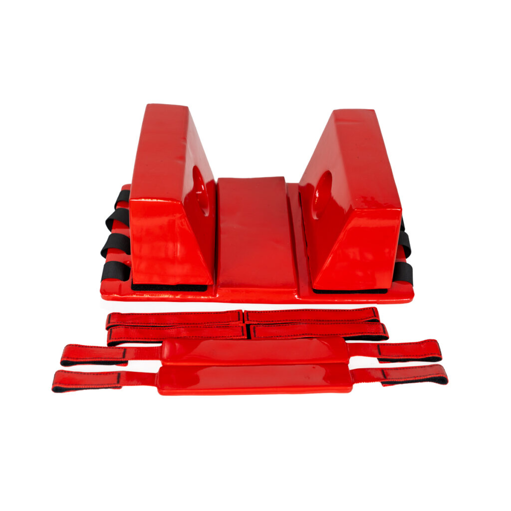 Red fitness balance blocks with attached ankle straps on a white background.