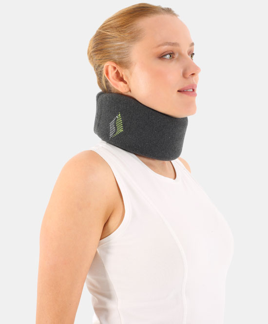 Profile of a woman wearing a dark foam cervical neck brace with a small green logo on the side